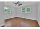 This bedroom boasts hardwood floors, a ceiling fan, and natural light from the two windows at 4669 Dunover Cir, Atlanta, GA 30360
