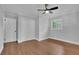 Bedroom featuring hardwood floors, a ceiling fan, a window, and a closet at 4669 Dunover Cir, Atlanta, GA 30360