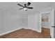 Neutral bedroom features hardwood floors, ceiling fan, closet, and a door with an adjacent room at 4669 Dunover Cir, Atlanta, GA 30360