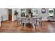 Bright dining room features hardwood floors, modern decor, and abundant natural light from large windows at 4669 Dunover Cir, Atlanta, GA 30360
