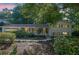 Charming two-story home with light green siding, shutters, mature trees, and landscaped front yard at 4669 Dunover Cir, Atlanta, GA 30360