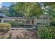 Charming home with manicured lawn, mature landscaping, and inviting front porch, set back from the street at 4669 Dunover Cir, Atlanta, GA 30360