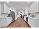 Modern kitchen with white cabinets, stainless steel appliances, hardwood floors, and marble countertops at 4669 Dunover Cir, Atlanta, GA 30360