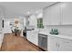 Bright kitchen with white cabinetry, stainless steel appliances, subway tile backsplash, and hardwood floors at 4669 Dunover Cir, Atlanta, GA 30360