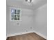 Laundry room featuring hardwood floors, a window, and a storage shelf at 4669 Dunover Cir, Atlanta, GA 30360