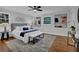 Spacious main bedroom with ceiling fan, two windows, hardwood floors, and stylish decor at 4669 Dunover Cir, Atlanta, GA 30360