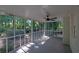 Screened porch featuring lush green outdoor scenery, ceiling fan, and access to the backyard at 4669 Dunover Cir, Atlanta, GA 30360
