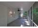 Screened porch with white brick exterior, ceiling fan, and access to outdoor landscape at 4669 Dunover Cir, Atlanta, GA 30360