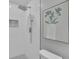 Modern shower with rainfall showerhead, white subway tile, and decorative niche with art at 4669 Dunover Cir, Atlanta, GA 30360
