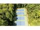 Aerial view of the community tennis courts, surrounded by mature trees, offering residents an active lifestyle at 4669 Dunover Cir, Atlanta, GA 30360