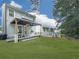 Expansive backyard featuring a covered patio area with seating, landscaping, and ample green space for outdoor activities at 499 Bishop Ln, Woodstock, GA 30188