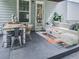 Backyard patio with a dining area, comfortable seating, a fire pit, and outdoor lighting, ideal for relaxing and entertaining at 499 Bishop Ln, Woodstock, GA 30188