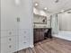 Bathroom with a vanity, large framed mirror and shower with a tub and blue shower curtain at 499 Bishop Ln, Woodstock, GA 30188