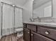 Cozy bathroom with a dark vanity, granite countertop, a toilet and framed mirror at 499 Bishop Ln, Woodstock, GA 30188