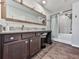 Bathroom featuring a granite vanity, framed mirror and a tub-shower with a patterned shower curtain at 499 Bishop Ln, Woodstock, GA 30188