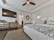 Spacious bedroom showcasing a large TV, ample dresser space, and a comfortable sleeping area at 499 Bishop Ln, Woodstock, GA 30188