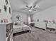 Bright bedroom featuring a floral bedspread, white furniture, and a ceiling fan at 499 Bishop Ln, Woodstock, GA 30188