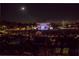A crowd enjoys an outdoor concert at night under a bright moonlit sky at 499 Bishop Ln, Woodstock, GA 30188