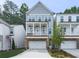 Charming home featuring a welcoming front porch, stone accents, and an attached two-car garage at 499 Bishop Ln, Woodstock, GA 30188