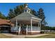 Picturesque gazebo with steps and green roof, set among trees and parked cars at 499 Bishop Ln, Woodstock, GA 30188