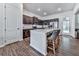 This modern kitchen boasts granite countertops, stainless steel appliances, and a spacious island with seating at 499 Bishop Ln, Woodstock, GA 30188