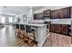 The kitchen features an open design, granite countertops, stainless steel appliances, and bar stool seating at 499 Bishop Ln, Woodstock, GA 30188