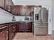 A well-appointed kitchen with stainless steel appliances, dark wood cabinets, and white subway tile backsplash at 499 Bishop Ln, Woodstock, GA 30188
