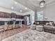 Open-concept living area with kitchen bar, comfortable seating, and a large rug at 499 Bishop Ln, Woodstock, GA 30188