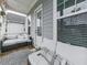 A covered front porch showing comfortable seating and outdoor furniture at 499 Bishop Ln, Woodstock, GA 30188