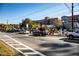 Street view in Woodstock, GA, showing a mix of cars, buildings, and pedestrian activity at 499 Bishop Ln, Woodstock, GA 30188