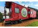 A red train car in Downtown Woodstock is surrounded by well maintained landscaping at 499 Bishop Ln, Woodstock, GA 30188