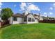 Backyard featuring an expansive lawn and modern home exterior at 3208 Spruce Way, Atlanta, GA 30349