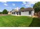 White home's backyard offers a spacious lawn and a privacy fence, perfect for outdoor activities and relaxation at 3208 Spruce Way, Atlanta, GA 30349