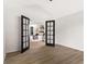 View from the office into the bedroom featuring hardwood floors, and a large bed at 3208 Spruce Way, Atlanta, GA 30349