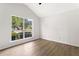 A bedroom features vaulted ceilings, wood-look floors, and a bright window at 3208 Spruce Way, Atlanta, GA 30349