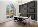 Stylish dining area with modern decor, including an accent wall and large window for natural light at 3208 Spruce Way, Atlanta, GA 30349