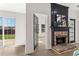 Image of a brick fireplace with black mantle adjacent to large sliding glass doors at 3208 Spruce Way, Atlanta, GA 30349