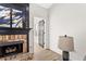 Close up of a brick fireplace with a black mantle, art, and light hardwood flooring at 3208 Spruce Way, Atlanta, GA 30349
