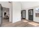 Sunlit foyer showcasing luxury vinyl plank flooring and entryways to various rooms at 3208 Spruce Way, Atlanta, GA 30349