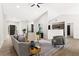 Bright living room with a ceiling fan, light hardwood flooring, and neutral color furniture at 3208 Spruce Way, Atlanta, GA 30349