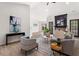 Bright living room with a brick fireplace, ceiling fan, light hardwood flooring, and neutral color furniture at 3208 Spruce Way, Atlanta, GA 30349