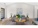 Bright living room with a ceiling fan, light hardwood flooring, and neutral color furniture at 3208 Spruce Way, Atlanta, GA 30349