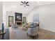 Bright living room with a brick fireplace, ceiling fan, light hardwood flooring, and neutral color furniture at 3208 Spruce Way, Atlanta, GA 30349