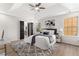 Bright main bedroom with a tray ceiling, ceiling fan, new windows, and an ensuite bathroom at 3208 Spruce Way, Atlanta, GA 30349