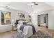 Bright main bedroom with a tray ceiling, ceiling fan, new windows, and an ensuite bathroom at 3208 Spruce Way, Atlanta, GA 30349