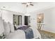 Bright main bedroom with a tray ceiling, ceiling fan, new windows, and a marble console table at 3208 Spruce Way, Atlanta, GA 30349