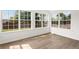 Bright sun room with large windows, light colored walls, and luxury vinyl plank flooring at 3208 Spruce Way, Atlanta, GA 30349