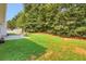 Lush green backyard featuring a swing and patio area with lawn at 3419 Allie Dr, Snellville, GA 30039