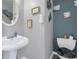 Stylish half-bathroom featuring a pedestal sink, toilet and decorative wall art at 3419 Allie Dr, Snellville, GA 30039