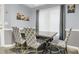 Dining room with grey walls, dining table, patterned chairs, and large window at 3419 Allie Dr, Snellville, GA 30039